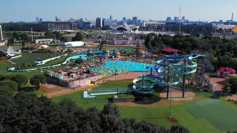 Public pool, water park, people in the pool on yellow swimming rings sunbathing Stock Footage 157145209