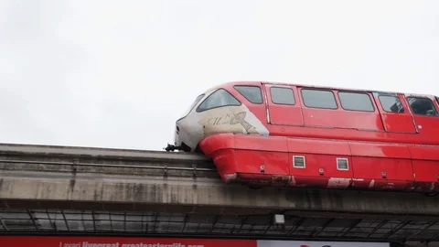 Public red train riding on bridge above city shops, Kuala Lumpur, Malaysia Stock Footage 146560134
