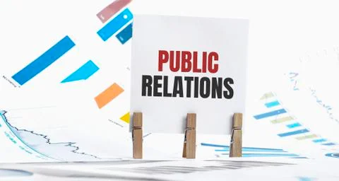 Public relations text on paper sheet with chart, dice, spectacles, pen, lapto Stock Photos