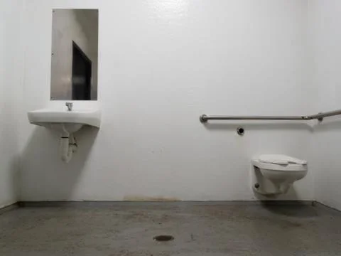 Public restroom toilet and mirror sink and WC bowl Stock Photos