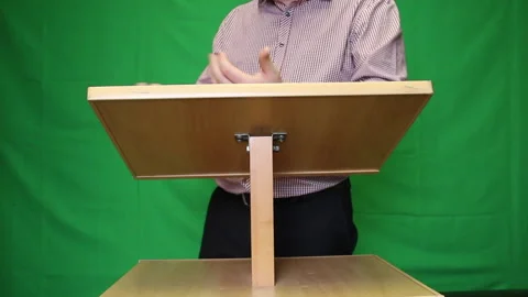 Public speaker behind the podium. A man in a shirt without a tie says somethi Stock Footage 221311129
