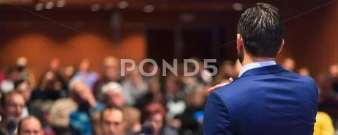 Public speaker giving talk at Business Event. Stock Photos