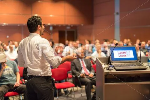Public speaker giving talk at Business Event. Stock Photos