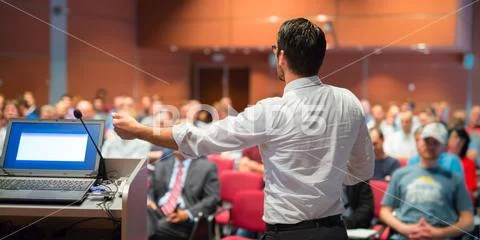 Public speaker giving talk at Business Event. Stock Photos