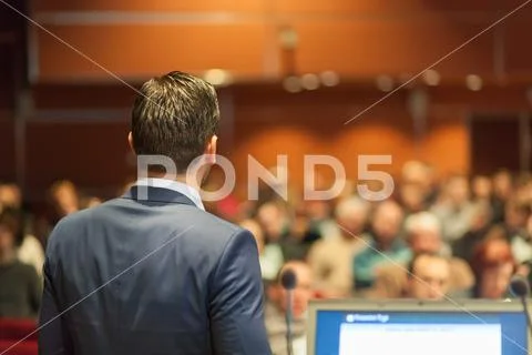 Public speaker giving talk at Business Event Stock Photos