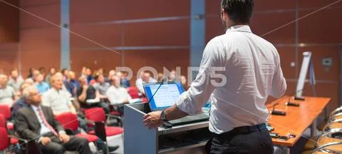 Public speaker giving talk at Business Event Stock Photos