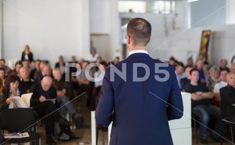 Public speaker giving talk at Business Event. Stock Photos