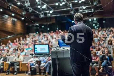 Public speaker giving talk at Business Event. Stock Photos
