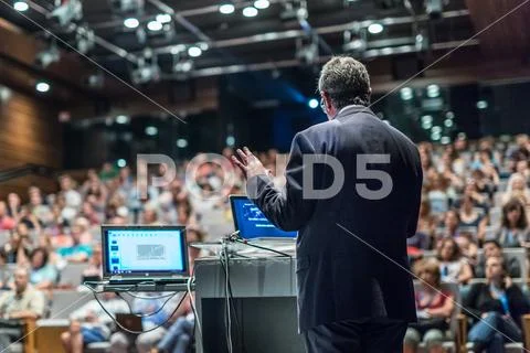 Public speaker giving talk at Business Event. Stock Photos