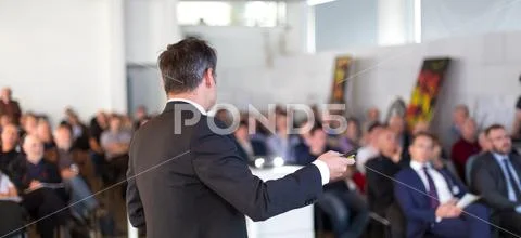 Public speaker giving talk at Business Event. Stock Photos