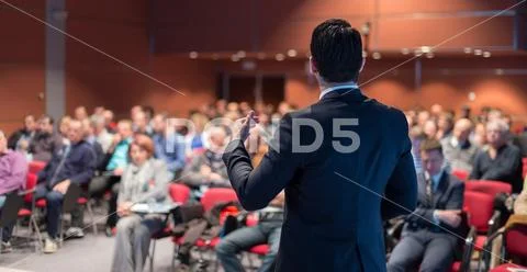 Public speaker giving talk at business event. Stock Photos