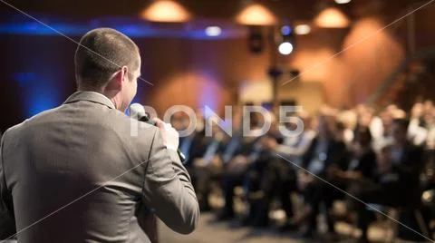 Public speaker giving talk at business event. Stock Photos