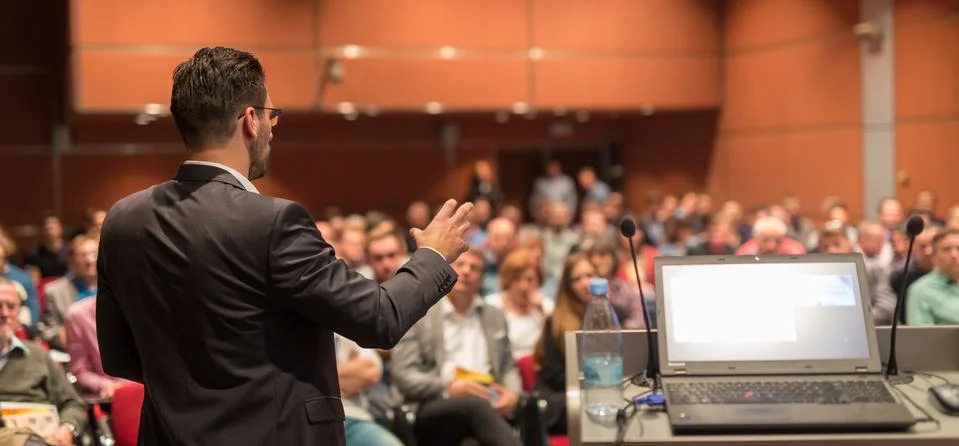 Public speaker giving talk at Business Event. Stock Photos