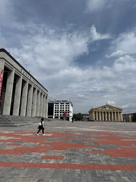 Public square with modern and classical buildings, cloudy sky Stock Photos