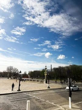 Public square scene in Paris with clear sky and historical architecture Stock Photos