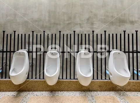 Public toilet room - comfort male Toilet Urinal, white urinals in public toil Stock Photos