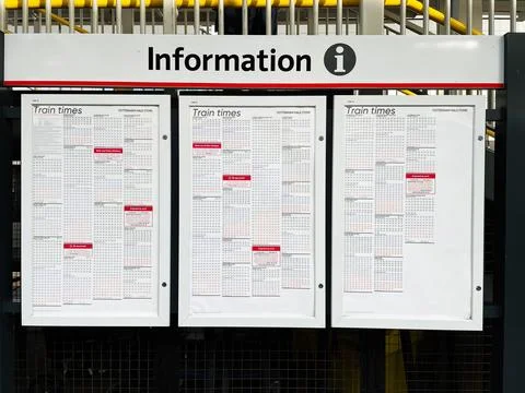 Public train timetable display board at a transit station for commuter info.. Stockfoto's