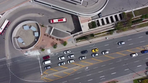 Public transit buses leaving and entering busy city subway station; aerial Stock Footage 221759284