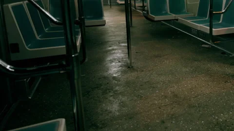 Public transport interior with empty seats and wet floor in evening light Stock Footage 343576078