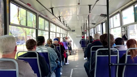 Public transport.Different multinational citizens sit in a tram. Rear view Stock Footage 192958196