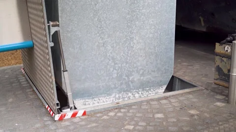 Public trash can being lowered after garbage truck pickup Stock Footage 280770723