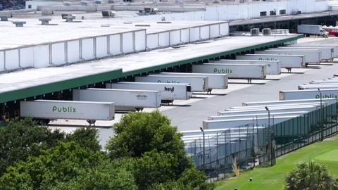 Publix distribution center loading docks line rows of semi-truck trailers Stock Footage 339035136