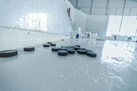 Pucks on ice ring Stock Photos