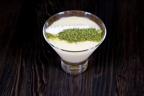 Pudding decorated with peanuts and coconut in a glass cup 스톡 사진