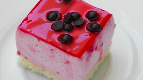 Pudding with strawberry jam and chocolate decoration, top view closeup Video stock 54338184
