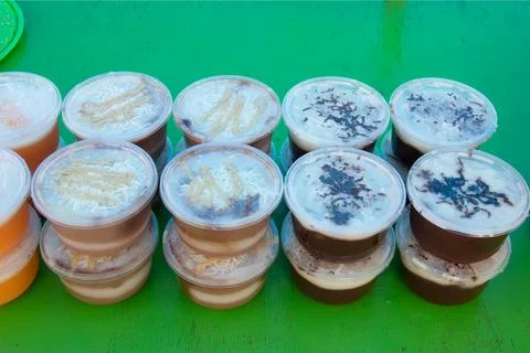 Puddings in plastic containers Stock Photos