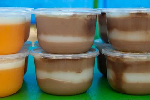 Puddings in plastic containers Stock Photos