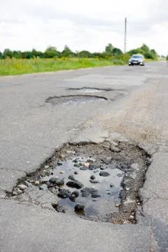 Puddle and rubbles in chuckhole Stock Photos