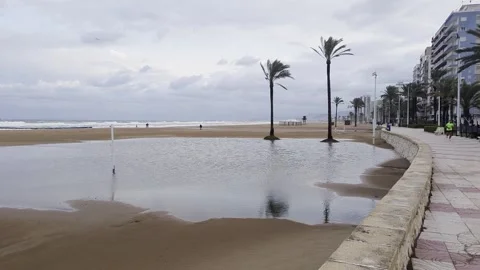 Puddle on Cullera beach after heavy rain – Valencia, Spain Stock Footage 318746310