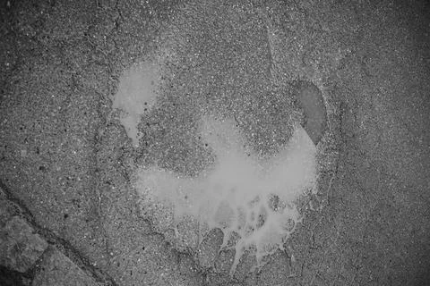 Puddle of engine oil forming an abstract shape on asphalt 写真素材