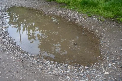 Puddle on the ground after rain Stock Photos