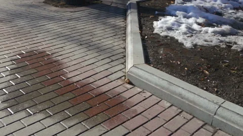 A puddle of heart-shaped water side view. Camera movement left to right, medium Stock Footage 87668264