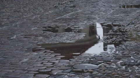 Puddle on old cobblestones road, Raining in European City scene, Tilt Shot Vídeos de archivo 248681042