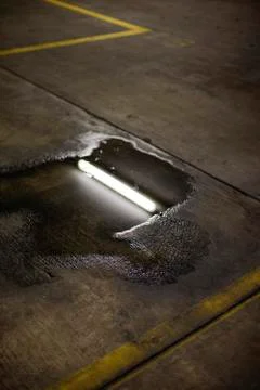 A puddle on the pavement of carparking Stock Photos