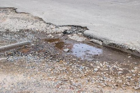 Puddle in a pit on an asphalt road Stock Photos