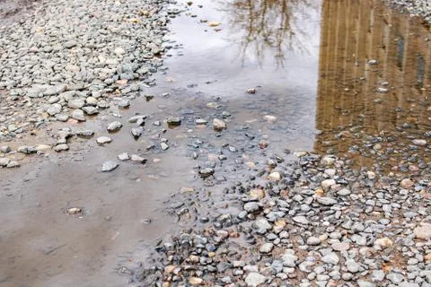 Puddle in a pit on an asphalt road Stock Photos