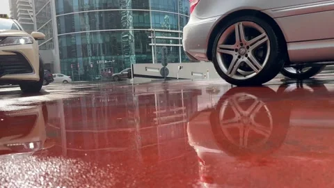 Puddle on red road with car wheel , mirroring Stock Footage 231407080