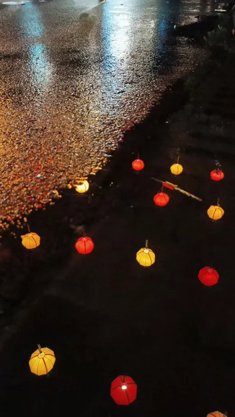 Puddle reflection of multi-colored lanterns in Hoi An old town Stock Footage 247870403
