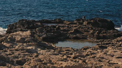 Puddle on a rock on the beach Stock Footage 147460039