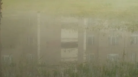 Puddle steam reflection in a puddle Stock Footage 64569197