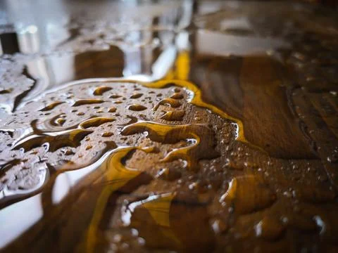 Puddle of water and rain drops on a wooden platform Stock Photos