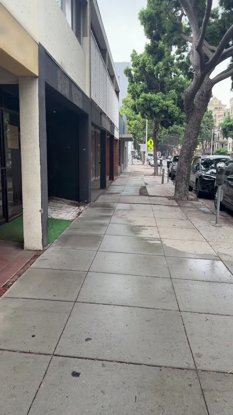 Puddles along an empty sidewalk after rain, Santa Monica Video stock 345265597