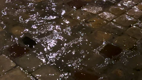 Puddles, streams of water, reflection of light from electric lamps during a rain Video stock 295821263