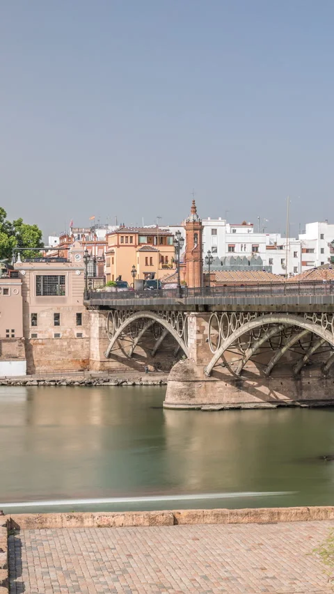 Puente de Isabel II bridge timelapse hyperlapse over the Guadalquivir River Stock Footage 319894754