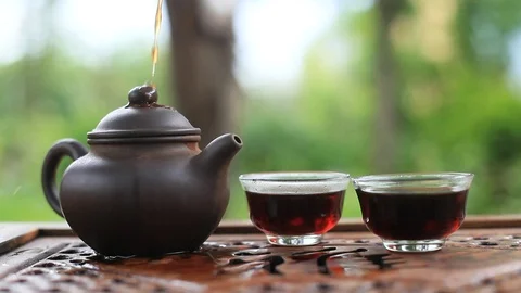 Puer tea is poured into cups. Close-up. Stock Footage 74128764