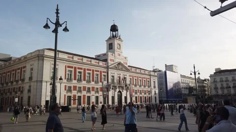 Puerta del Sol Madrid Spain Handheld View of Clock Tower with Crowds at Sunset 스톡 동영상 339036236